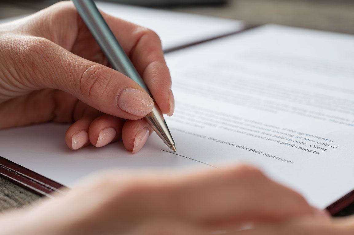 female hand signing document